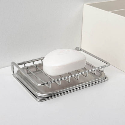 Soap holder with slotted design draining excess water into the sink
