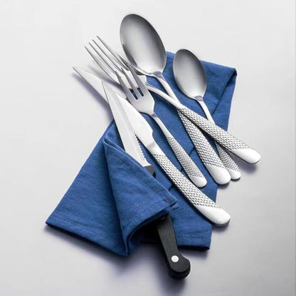 stainless steel flatware set arranged with napkins